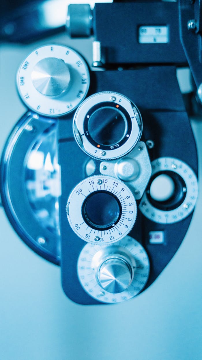 Detailed view of a phoropter used in eye examinations, showcasing precision dials and lenses.